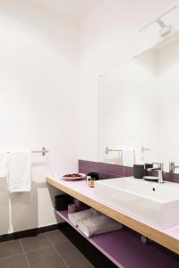 a bathroom with a sink and a mirror at TorinoToStay Apartments in Turin