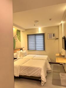 Postel nebo postele na pokoji v ubytování Maharlika City Inn