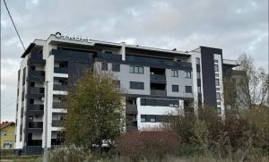 a building with a sign on the top of it at Modern Apartment MOMENT in Brčko