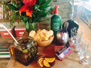 a table with a bottle of wine and a bowl of fruit at Can Barrina in Montseny