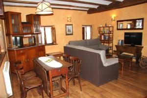 a living room with a couch and a table at Ca María Fayas in Proaza