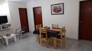 a dining room with a table and chairs and a television at Viento Zonda in Santa María +18 photos