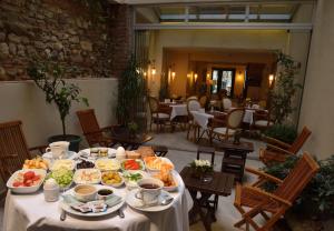 a table with food on it in a restaurant at By Murat Royal Hotel Galata in Istanbul