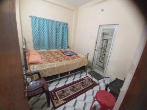 a small bedroom with a bed and a mirror at Shiv sakti homestay in kolkata +15 photos