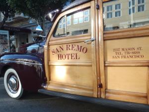 an old wooden van is parked on the street at San Remo Hotel in San Francisco