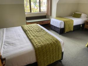 Postel nebo postele na pokoji v ubytování Allan Court Motel