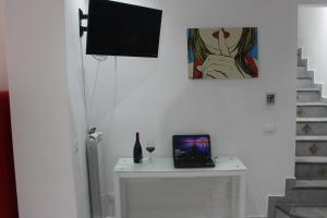 a room with a table with a laptop on it at B&B Xenia in Palermo