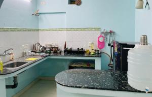 a kitchen with a sink and a counter top at Best Homestay in Puttaparthi