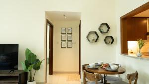 a dining room with a table and a tv at Modern Apartment near Burj khalifa in Dubai