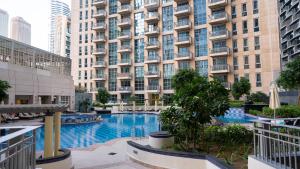 a large apartment building with a large swimming pool at Modern Apartment near Burj khalifa in Dubai