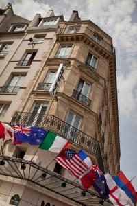 a tall building with flags in front of it at Hotel Agora in Paris