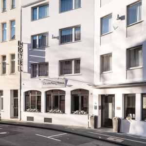 a white building with a pharmacy pharmacy sign on it at Hotel Deutsches Haus in Bonn