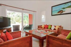 a living room with a couch and a coffee table at 5 BD Luxury Villa with Large Pool & Minutes from Beach in Puerto Aventuras