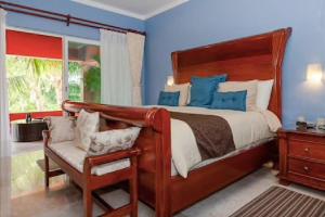 a bedroom with a bed and a chair and a window at 5 BD Luxury Villa with Large Pool & Minutes from Beach in Puerto Aventuras +70 photos
