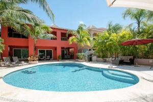 a large swimming pool in front of a building at 5 BD Luxury Villa with Large Pool & Minutes from Beach in Puerto Aventuras