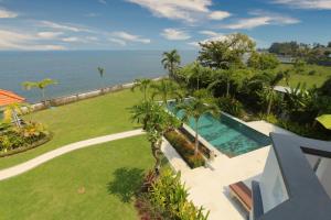 an aerial view of a resort with a swimming pool and the ocean at Saujana, Beachvilla with 3 bedrooms in Singaraja