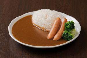 a plate of rice and carrots and broccoli on a table at Meitetsu Inn Nagoya Nishiki in Nagoya