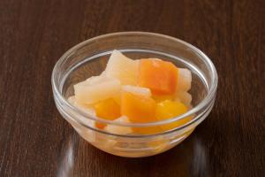 a glass bowl filled with cheese and fruit on a table at Meitetsu Inn Nagoya Nishiki in Nagoya