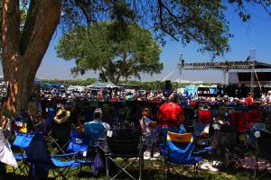 a crowd of people sitting in chairs at a concert at My Home Is Your Home home in Grand Junction