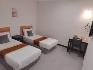 Postel nebo postele na pokoji v ubytování CMN Hotel & Homestay