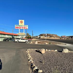 an empty street with a motel sign in the background at Ramblin Rose Motel in Kingman