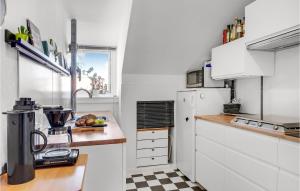 a kitchen with white appliances and a counter top at Stunning Apartment In København Sv in Copenhagen