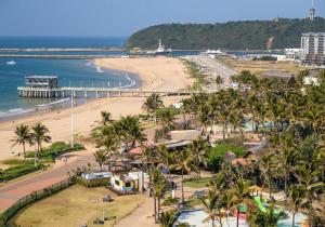 an aerial view of a beach with palm trees at Shaka Shores 7E in Durban