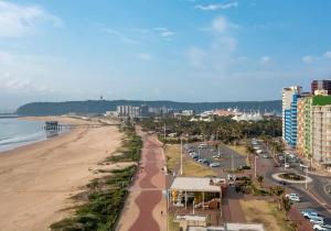 a view of a beach with buildings and a city at Shaka Shores 7E in Durban