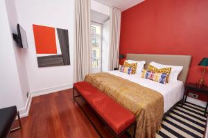 a red bedroom with a bed with a red wall at Martinhal Lisbon Chiado in Lisbon