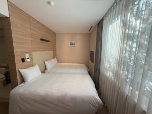 Łóżko lub łóżka w pokoju w obiekcie Acube Hotel Dongdaemun