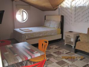 Postel nebo postele na pokoji v ubytování Bella Suit Apart Hotel
