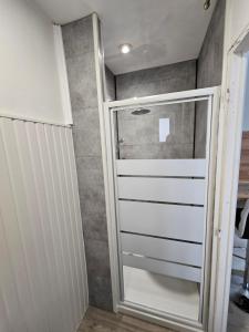 a walk in closet with a glass door at La famille 1 in Angoulême