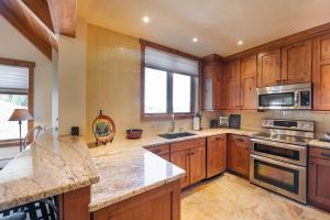 a kitchen with wooden cabinets and a stove top oven at Premium Unit 2801 - Zephyr Mountain Lodge condo in Winter Park