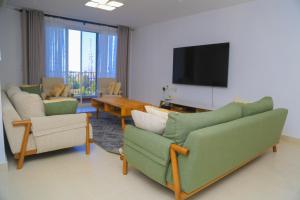 a living room with couches and a flat screen tv at 300 Rentals in Dar es Salaam