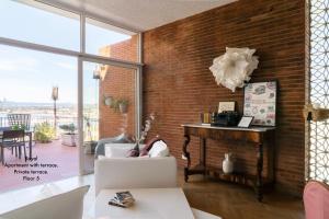 a living room with a brick wall at Appartamenti di Casa VerbaVolant in Syracuse