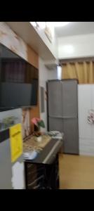 a kitchen with a counter top with a plant on it at Sweet Stay at Manila in Manila