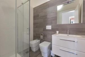 a bathroom with a toilet and a sink and a mirror at Casa Silvana in Copertino