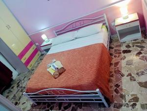 a bedroom with a large bed with a red blanket at PignaRossa Appartamenti in Mongiove
