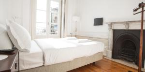 
A bed or beds in a room at Porto Republica Hostel & Suites
