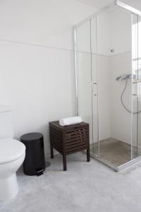 a bathroom with a toilet and a glass shower at Republica Boutique Hostel in Porto +44 photos