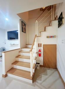 a staircase in a house with a living room at DeliZia de Budget พักได้ 2 ท่าน in Satun