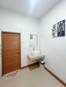 a bathroom with a sink and a brown door at DeliZia de Budget พักได้ 2 ท่าน in Satun +110 photos