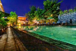 a swimming pool at a resort at night at Apartment Green Amazon in Siem Reap