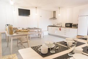 a kitchen with a table and chairs and a kitchen with a counter at Porto Republica Hostel & Suites in Porto