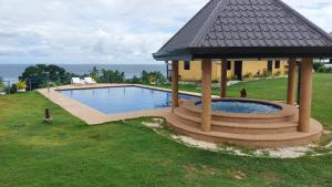 a swimming pool with a gazebo next to a house at Seaview Moonrise Café in Alcoy