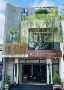 a building with plants on the side of it at Nội homestay in Hue