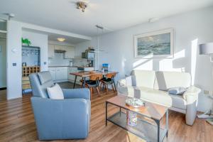 a living room with a couch and a table at Appartementencomplex Juliana 78 in De Koog