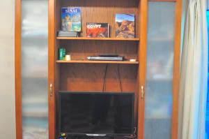 a book shelf with a television in it at Backpackers in Sharm El Sheikh