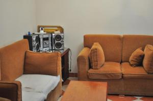 a living room with a couch and a chair at Backpackers in Sharm El Sheikh +1 photo