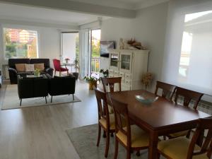 a dining room and living room with a table and chairs at Urdaibai Luxy in Pedernales +42 photos